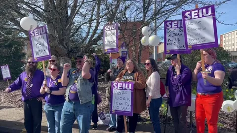 Local 083 members rally on campus with signs calling for fair pay and respect